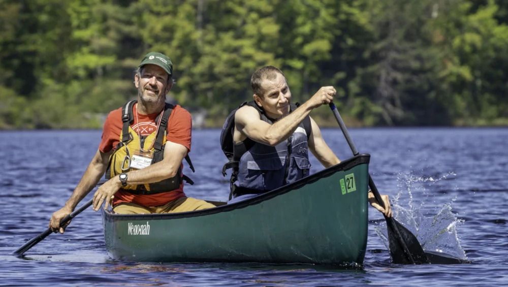 two people paddling a canoe together