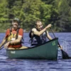 two people paddling a canoe together