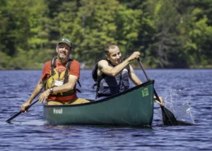 two people paddling a canoe together