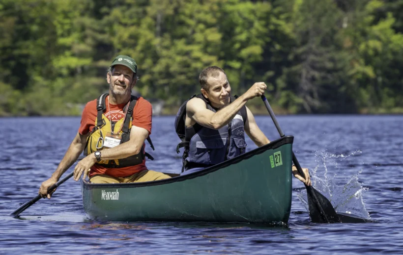 two people paddling a canoe together