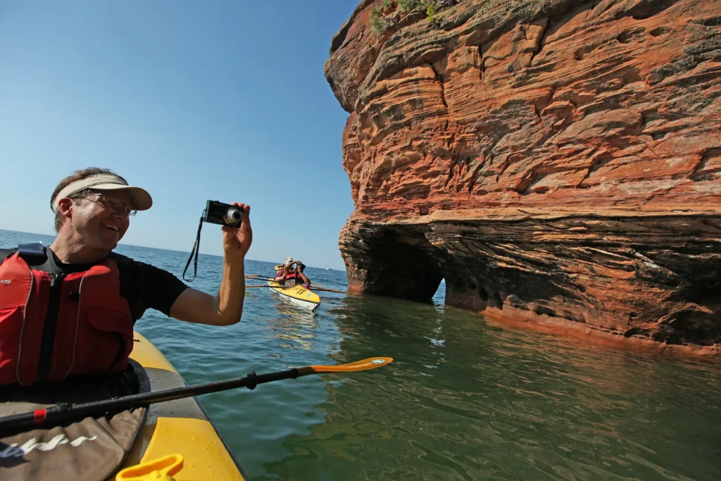 kayaker in apostle islands photographing rocks